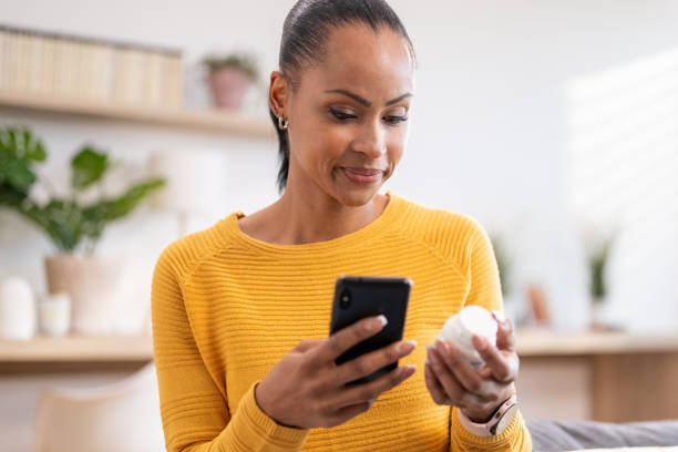 A woman checking her medication details on her phone